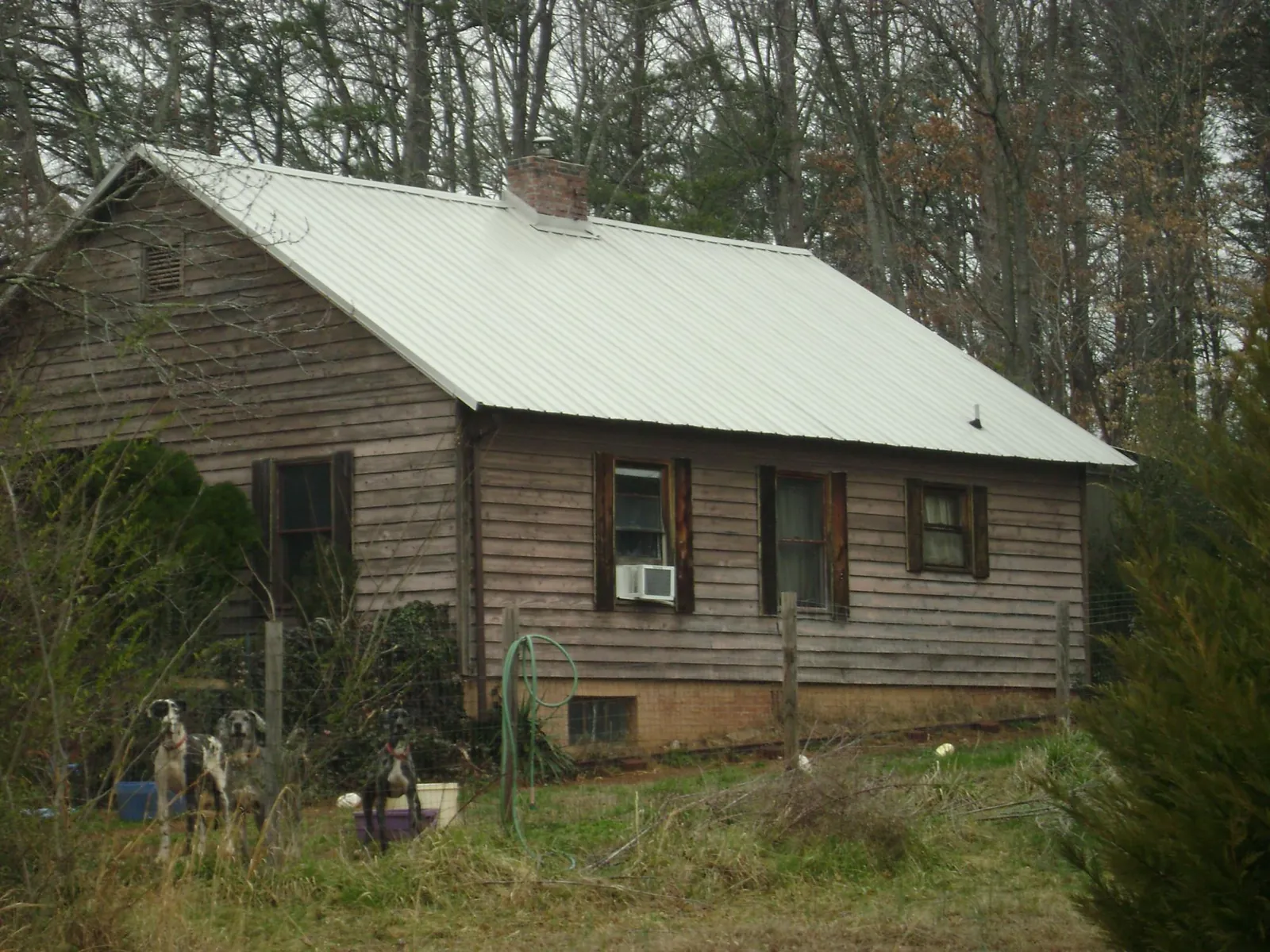 White metal roof on an old wood sided farmhouse, from a Metal Roof Installation job in Barwick